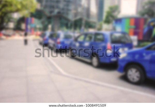 Blurred group of blue taxi as background located\
in Kuala Lumpur