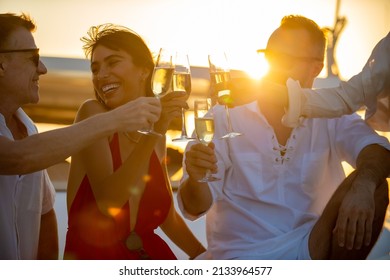 Blurred Group of People man and woman friends enjoy party drinking champagne together while catamaran boat sailing at summer sunset. Male and female relax outdoor lifestyle activity on travel vacation - Powered by Shutterstock