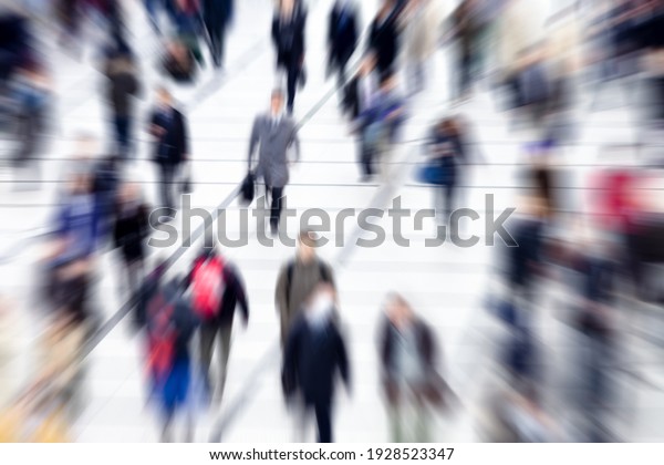 Blurred group of\
people walking during rush\
hour