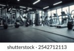 blurred gym background, sports fitness room with treadmills and exercise equipment in defocus, and text copy space