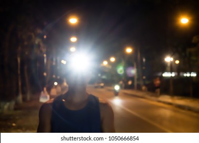 Blurred Headlamp Runner With Light Flares,Night Run Safety Concept.