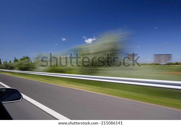 Blurred highway scene\
from a car window