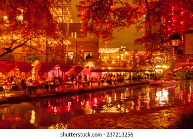 Blurred Holiday Background. River Walk  In San Antonio City At Night In Christmas Season, Texas, USA