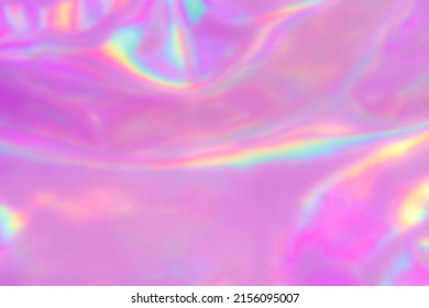 Blurred Holography Background In Pink Color. Holographic Colour Wrinkled Pearlescent Foil. Holographic Iridescent Rainbow Fabric Abstract Background.