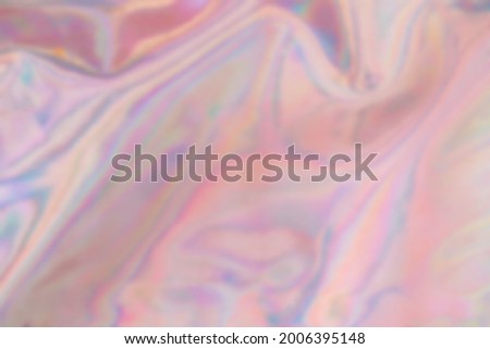 Blurred Holography cloth texture in pastel blue pink green colors irregularities. Holographic color wrinkled pearlescent foil. Trendy creative soft pastel gradient.