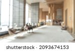 Blurred hotel or office building lobby blur background interior view toward reception hall, modern luxury white room space with blurry corridor and building glass wall window