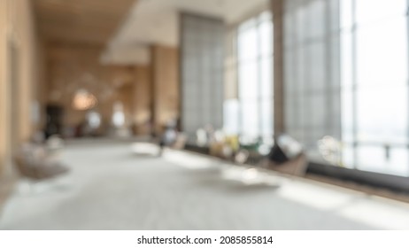 Blurred hotel or office building lobby blur background interior view toward reception hall, modern luxury white room space with blurry corridor and building glass wall window - Shutterstock ID 2085855814