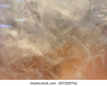 Blurred Ice And Water In A White Plastic Jug