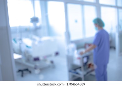 Blurred ICU Room In A Hospital With Medical Equipments And Patient.