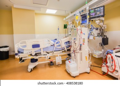 Blurred ICU Room In A Hospital With Medical Equipments And Patient.