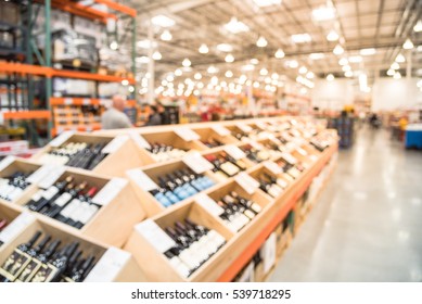 Blurred Image Aisle Of Bottles In Wine Section Of Modern Distribution Warehouse With Customers Choosing Wine. Inventory, Logistic, Business, Wholesale, Export Concept. Beverage Alcohol Background.