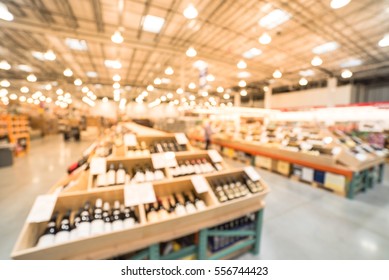 Blurred Image Aisle Of Bottles In Wine Section Of Modern Distribution Warehouse With Customers Choosing Wine. Inventory, Logistic, Business, Wholesale, Export Concept. Beverage Alcohol Background.