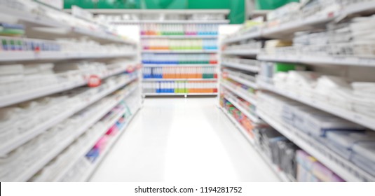 Blurred Image Of Aisle And Office Equipment In Stationary Store  Or Supermarket With Colorful Shelves With Green Background ,concept Of Hypermarket Bussiness Use As Background,backdrop Or Wallpaper.