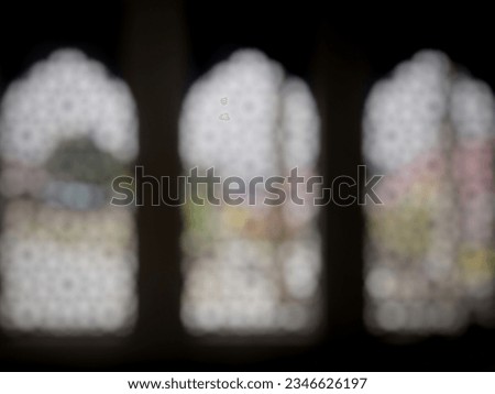 Blurred image of arched mosque window silhouette. Defocused abstract background.