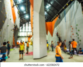 Blurred image  Attractive of many people climbing up the wall in gym - Powered by Shutterstock