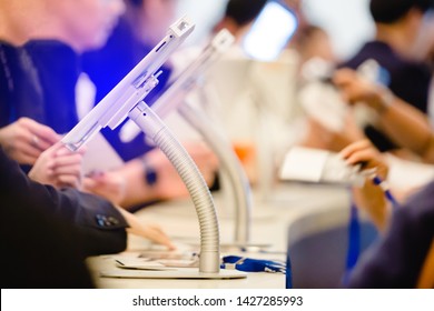 Blurred Image For Background Of Hand And Tablet For Registration In To Seminar Event Or Meeting With People. The Concept Of Electronic Registration.