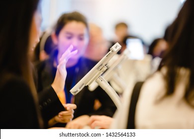 Blurred Image For Background Of Hand And Tablet For Registration In To Seminar Event Or Meeting With People. The Concept Of Electronic Registration.