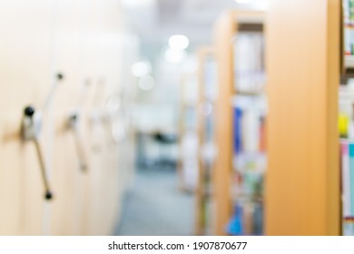 Blurred Image For Background Of Many Books On Bookshelf In Library.