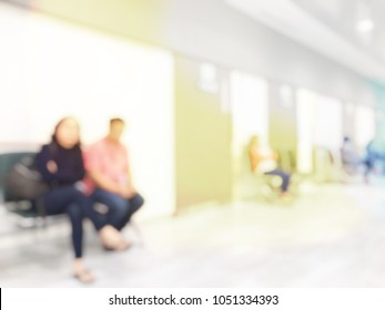 Blurred Image Background Of The Number Of Patients Sitting And Waiting For See Doctor Or Treatment In Hospital In Front Of Room Due To Bad Weather. Vintage Tone With Light Effect. Copy Space