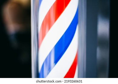 Blurred Image Barbershop. Vintage Window Pole For Barbershop. Illuminated Barbershop Pole Sign. Beautiful Barbershop Post Light