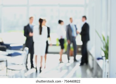blurred image of business people standing in office.business background