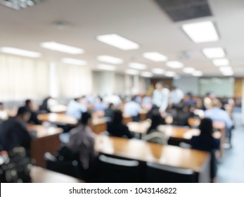 Blurred  image of business people and student sitting in conference room or meeting room for profession seminar with screen projector for showing information, education or training concept.