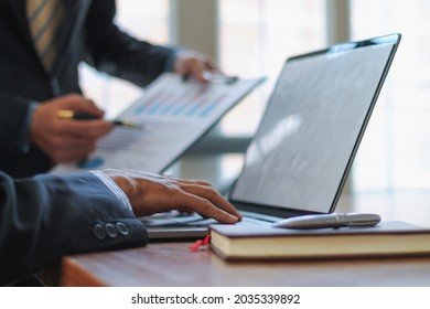 Blurred image, businessman is talking to an investment advisor to plan a real estate investment and discuss the budget to borrow from a financial institution to keep the business running smoothly. - Shutterstock ID 2035339892