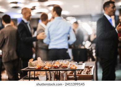 Blurred image of businesspeople at banquet event business meeting event. Business and entrepreneurship events concept. Focused on the canapes. - Powered by Shutterstock