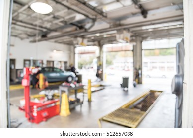 Blurred Image Of Car In Auto Shop. Defocused Background Of Modern Repair Shop. Small Car Oil Change Service Station At Little Rock, Arkansas, US. Interior Of Car Repair Shop With Working Auto Mechanic