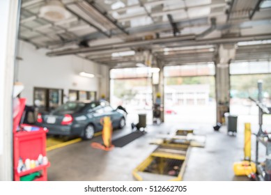 Blurred Image Of Car In Auto Shop. Defocused Background Of Modern Repair Shop. Small Car Oil Change Service Station At Little Rock, Arkansas, US. Interior Of Car Repair Shop With Working Auto Mechanic