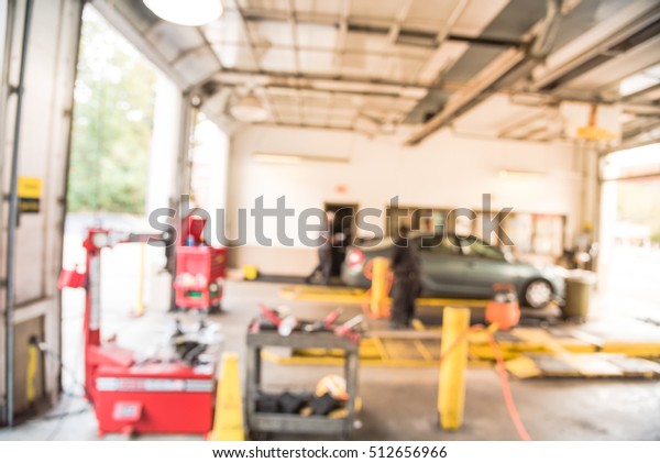 Blurred image of car in auto shop. Defocused
background of modern repair shop. Small car oil change service
station at Little Rock, Arkansas, US. Interior of car repair shop
with working auto
mechanic