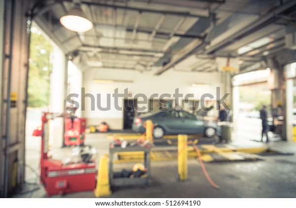 Blurred image of car in auto shop. Defocused
background of modern repair shop. Small car oil change service
station at Little Rock, Arkansas, US. Repair shop with working auto
mechanic. Vintage
filter