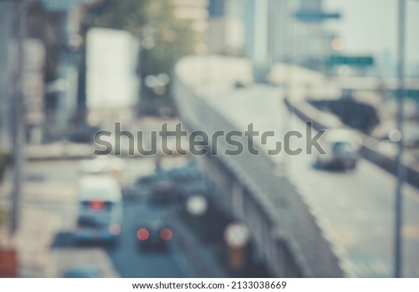 The Blurred image of a car driving on\
the road Traffic and bokeh from the melting of the len \
used. for\
scene background or wallpaper and design\
work.