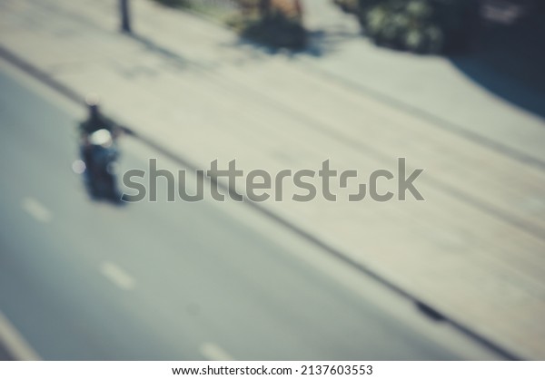 The Blurred image of a car driving on\
the road Traffic and bokeh from the melting of the len \
used. for\
scene background or wallpaper and design\
work.