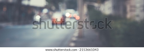 The Blurred image of a car driving on the\
road Traffic and bokeh from the melting of the len used. for scene\
background or wallpaper and design\
work.