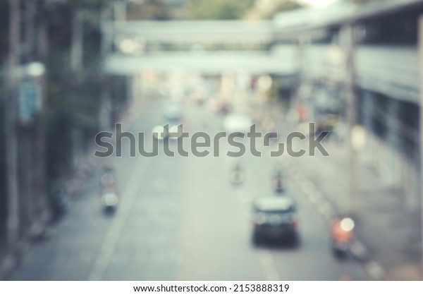 The Blurred image of a car driving on the\
road Traffic and bokeh from the melting of the len used. for scene\
background or wallpaper and design\
work.