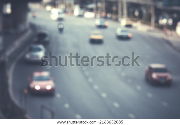 Blurred image of a car\
driving on the road and bokeh from lens melting for wallpaper,\
backdrop and design.
