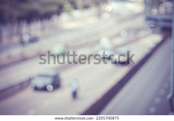 Blurred image of a car\
driving on the road and bokeh from lens melting for wallpaper,\
backdrop and design.