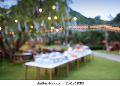 Blurred Image Of Celebrate Outdoor Party In The Garden Night Time For Background Usage.