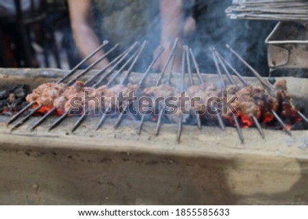 Similar – Man cooking on a barbecue