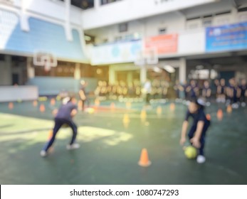 Blurred Image Of Children Or Male And Female Students In Secondary School Are Learning Football Or Soccer On School Playground In Physical Education Time. Bangkok,Thailand. Physical Activities Concept