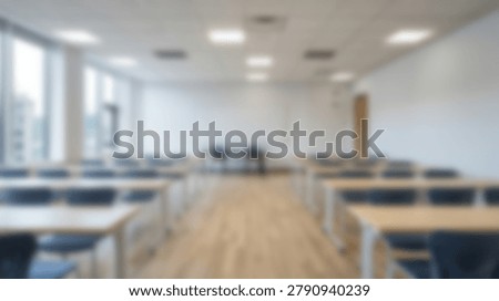 A blurred image of a classroom interior, featuring rows of desks and chairs, suggesting a learning environment. The image conveys a sense of anticipation and readiness for students and teachers.