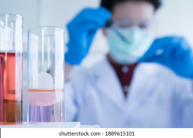 Blurred image Close up of Red and pink color liquid medicine in Test tube in rack on chemical table in the modern laboratory room. The education Chemistry and medical research concept. - Shutterstock ID 1889615101