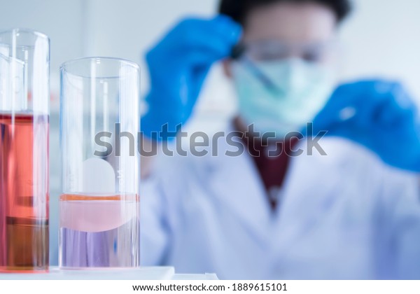 Blurred\
image Close up of Red and pink color liquid medicine in Test tube\
in rack on chemical table in the modern laboratory room. The\
education Chemistry and medical research\
concept.