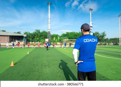 blurred image of Coach is coaching Children Training In Soccer Team