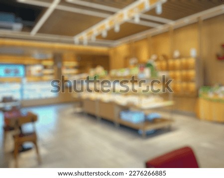Blurred image of coffee and bread store. Shelf full of various bread