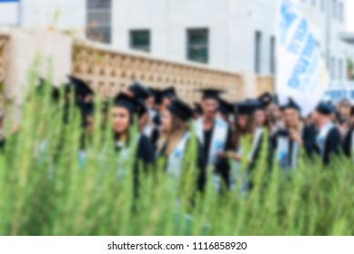 Blurred image College students at Graduation Ceremony.Group happy multiple races students in mortar boards and bachelor gowns outdor. - Shutterstock ID 1116858920