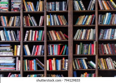 Blurred Image Of Colorful Books In Shelves