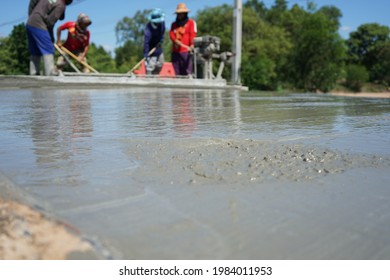 Blurred image of construction worker pouring concrete on structural work