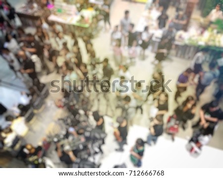 blurred image of crowd of people and production team, reporter and photographer waiting for grand opening new product  in exhibition hall event. Top view, View from Above, bird eye view